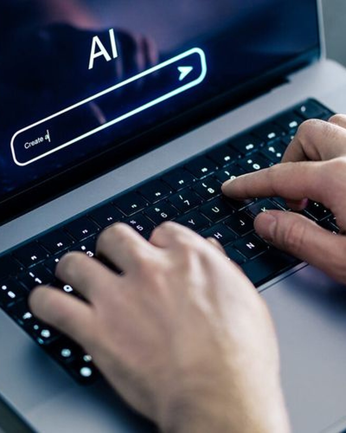 Hands typing on a laptop with an AI assistant ready to create, representing building your website and digital assets with AI
